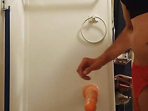 The lady moans and cum shots standing, without hands from the dildo in the ass)