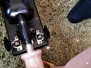 Crossdressing beauty in black lingerie, stockings and suspended is enjoying ass ride on fuck machine, her dick jumping in the rhythm.