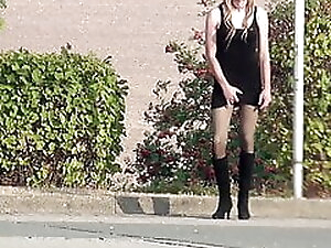 Crossdresser Sissy goes outside in minidress and boots